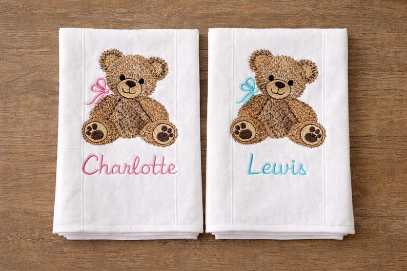 Two teddy bear burp cloths, one pink and one blue