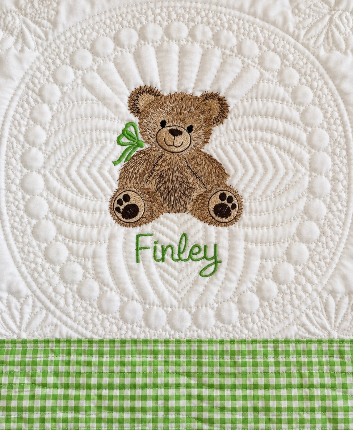 Personalized teddy bear baby quilt with green gingham trim and the name Finley embroidered in green