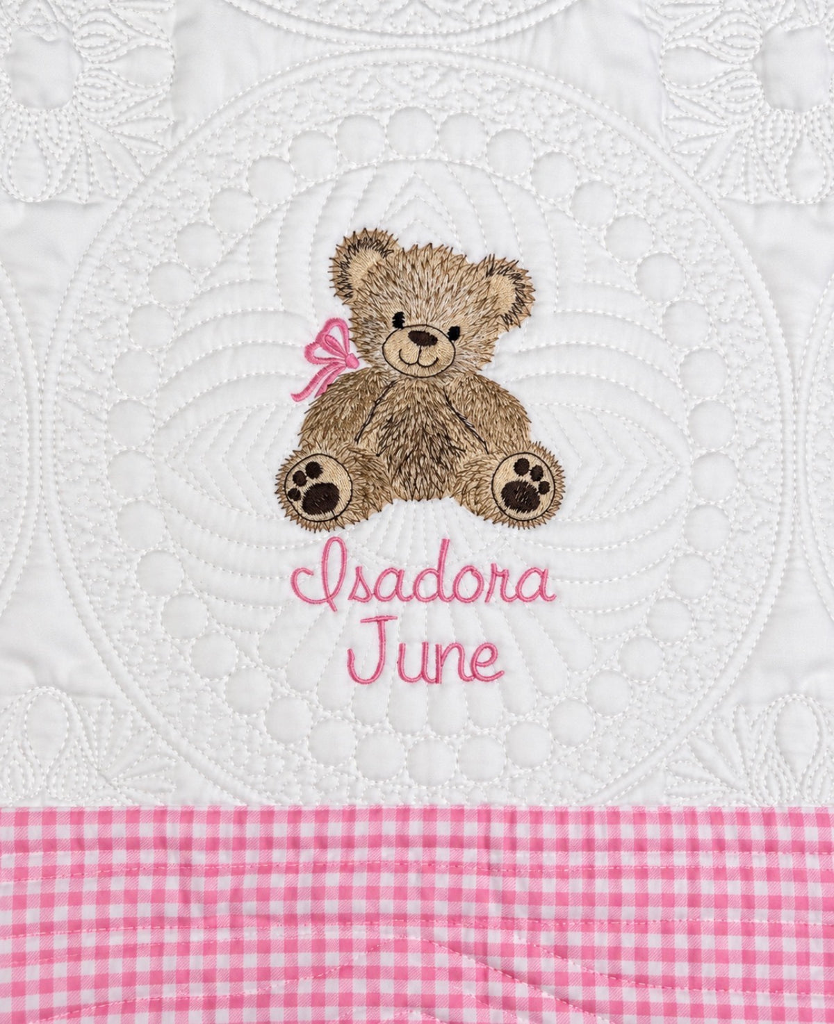 Personalized teddy bear baby quilt with pink gingham trim and the name Isadora June embroidered in pink