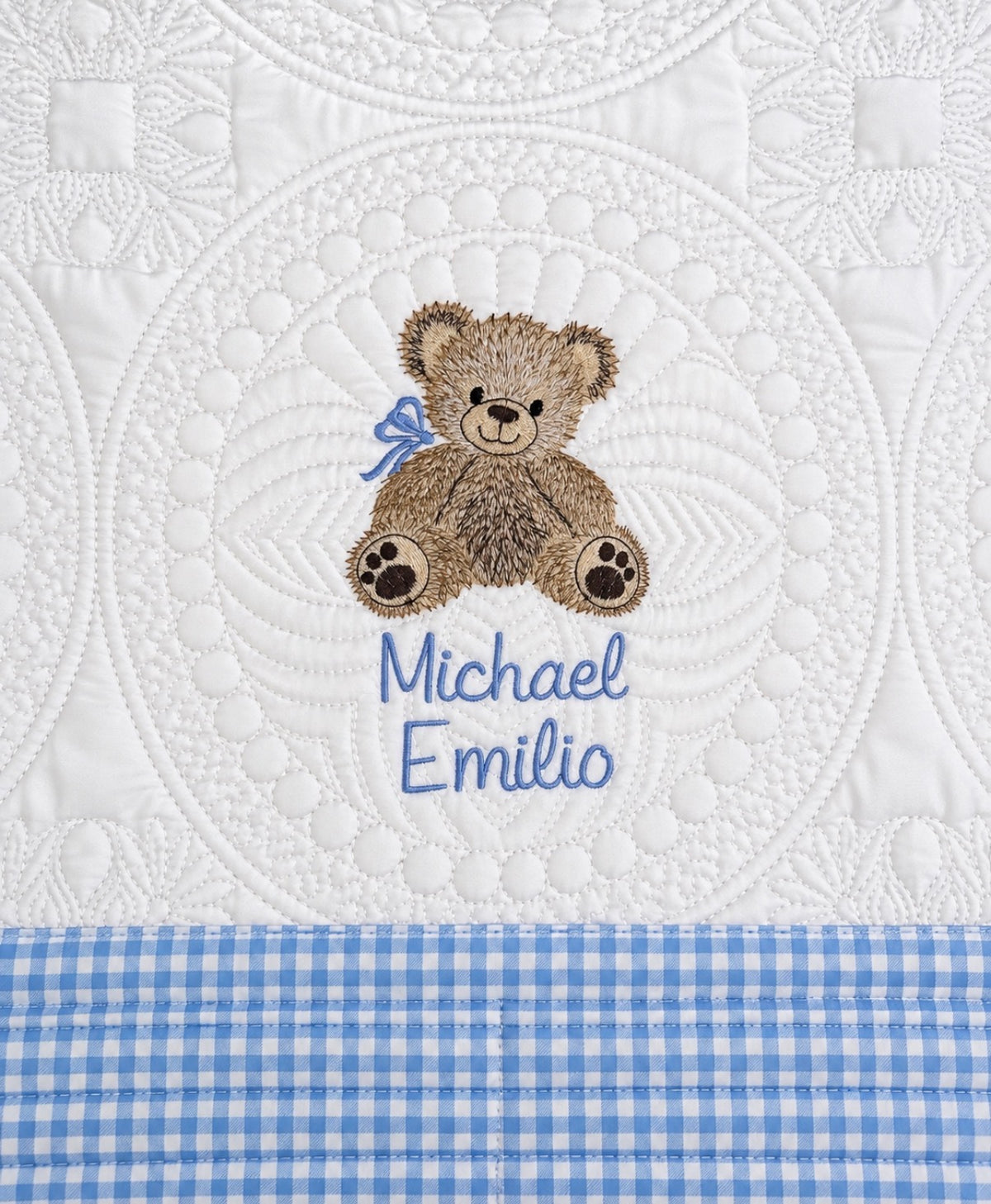 Personalized teddy bear baby quilt with light blue gingham trim and the name Michael Emilio embroidered in blue