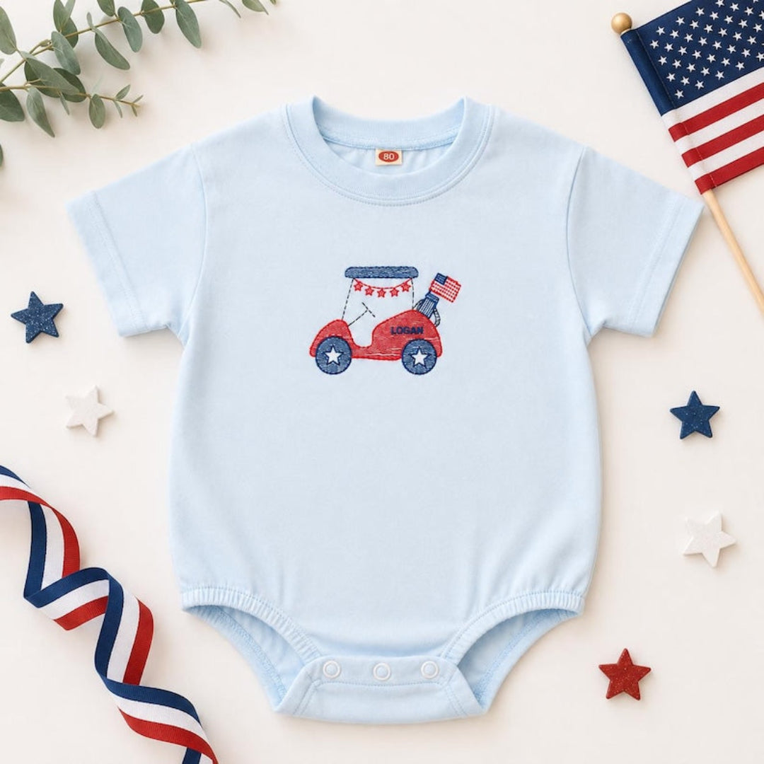 Light blue baby bubble romper with embroidered patriotic golf cart and the name Logan